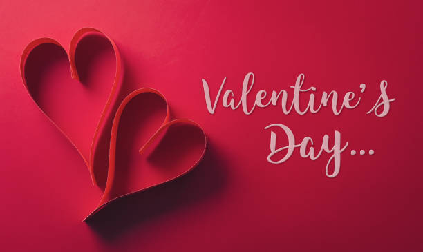 istock Love and Valentine's day concept made from paper hearts on dark red background. 2194792205