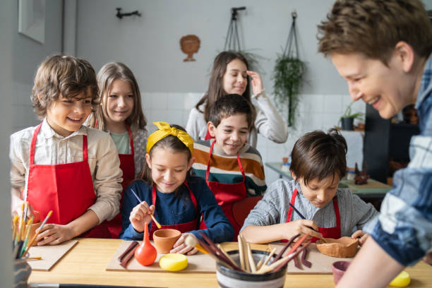 istock Children learning how to decorate clay bowls 2194795508