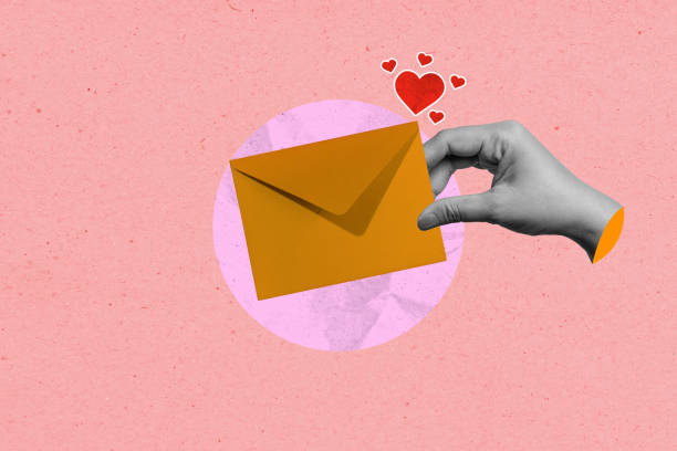 istock A human hand holding an envelope with red hearts on a colored background 2194802884