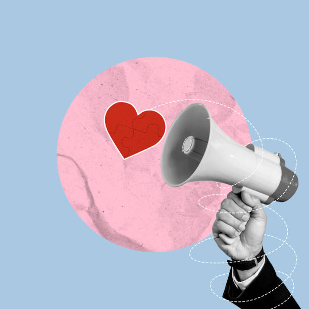 istock Business hand holding megaphone with red heart on a colored background 2194803088