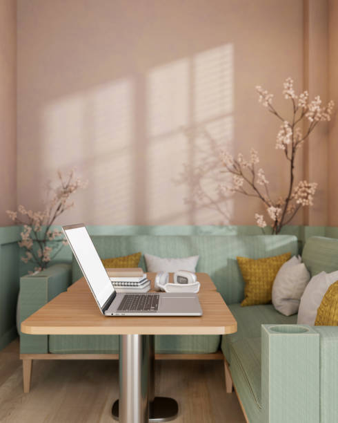 istock A laptop placed on a wooden table in modern pastel cafe or office lounge. 2194803318