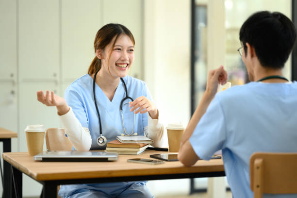 istock Friendly female medical student laughing and gesturing while talking to her classmate. 2194806421
