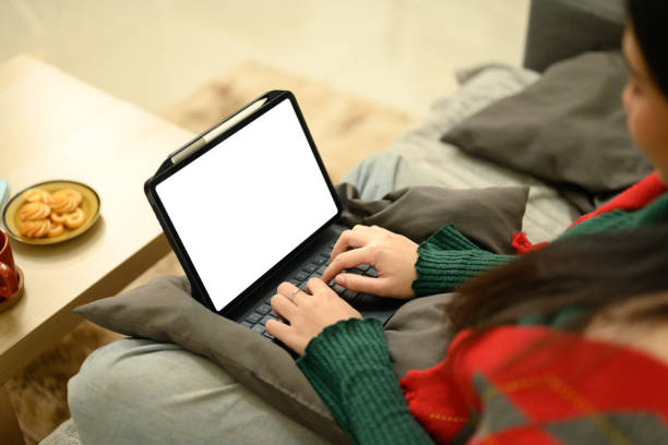 istock Cropped shot of young freelancer typing on digital tablet keyboard, sitting on a comfortable sofa. 2194806550