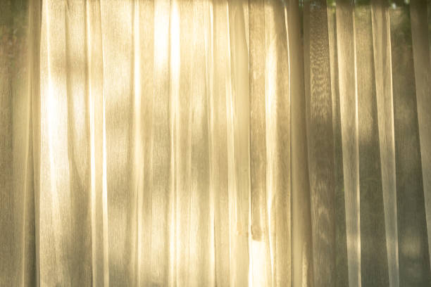 istock Soft light on curtains window. There was morning light through the window in room, looking at the view of the mountains and trees as the sun rose. 2194807784