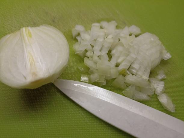 istock The onion in the section is partially crushed. 2194810506