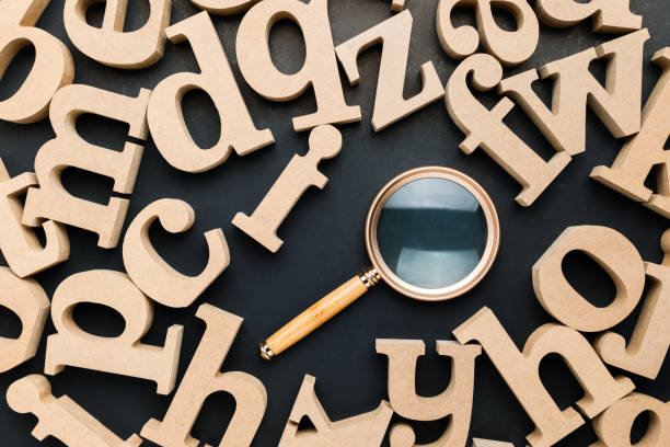 istock A magnifying glass placed in the scattered wooden letters 2194813135