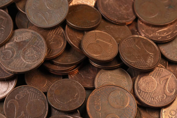 Small euro copper and gold coins scattered, emphasizing savings and wealth