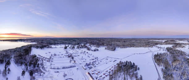istock Peaceful snowy landscape with sunset over Scandinavian forest and lake 2194815593