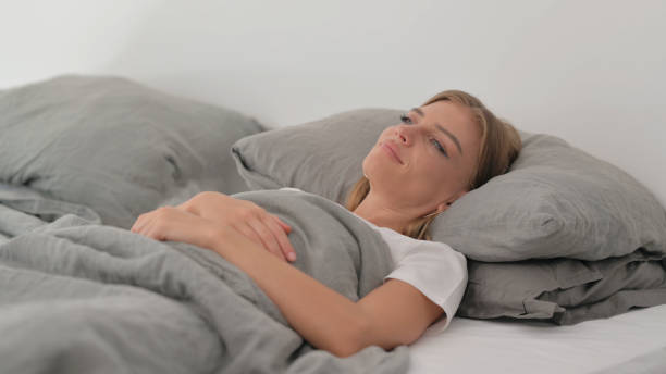 istock Pensive Young Woman Lying in Bed 2194815637