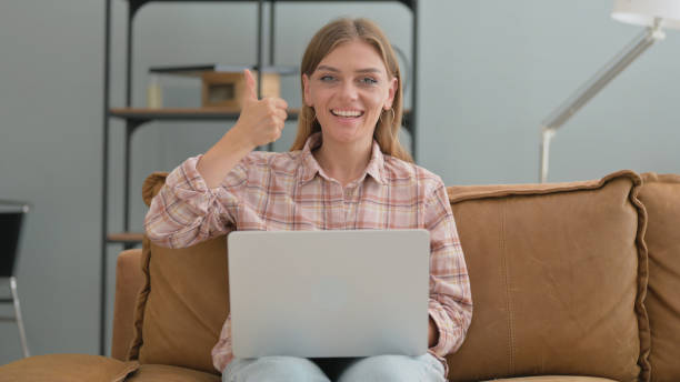 istock Thumbs Down by Young Woman Using Laptop Outdoor on Bench 2194817479