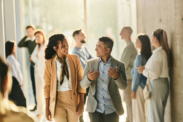 istock Diverse colleagues enjoying in conversation on the move in a hallway. 2194823748