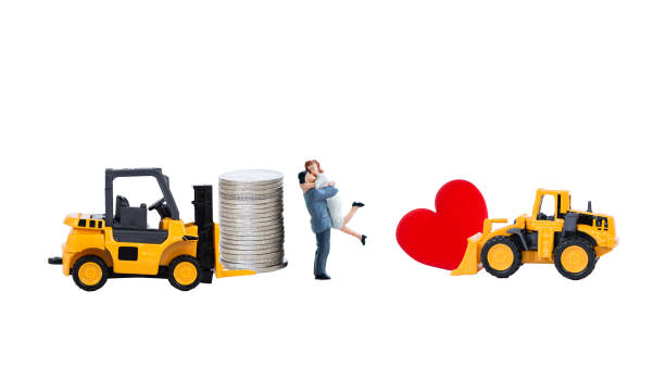 istock Miniature couple with coin stack and red heart on yellow truck isolate on white background 2194826124