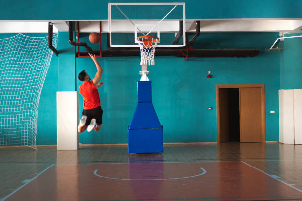 istock Basketball player scoring layup during training in gym 2194826209
