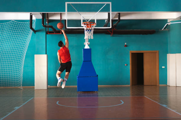 istock Basketball player shooting a ball in a gymnasium 2194826211