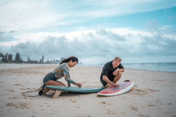 istock Diverse Surfing Couple Prepares Boards on Gold Coast Beach 2194826617