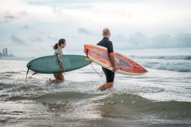 istock Joyful Surfing Couple Running into Waves on Gold Coast 2194826645