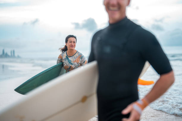 istock Joyful Surfing Couple on Gold Coast Beach 2194826662
