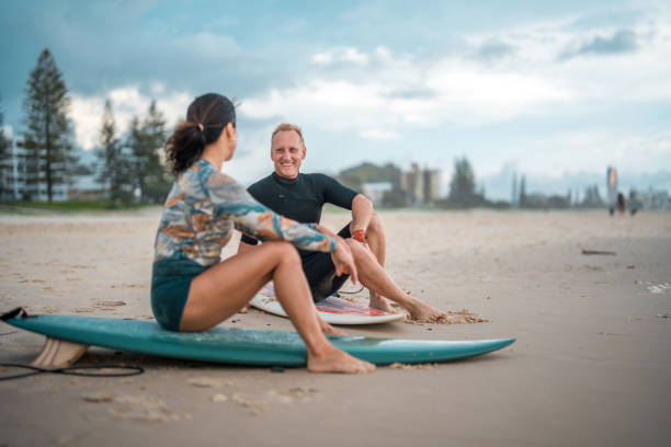 istock Cheerful Surfing Couple on Gold Coast Beach 2194826665