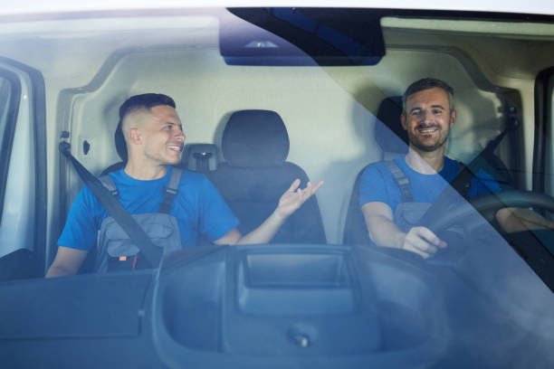 istock Happy workers talking on the way to delivery in a van. 2194826674