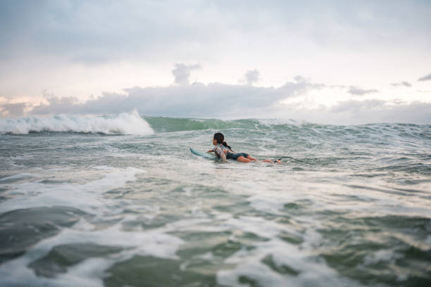 istock Determined Asian Female Surfer Riding Waves at Gold Coast 2194826698