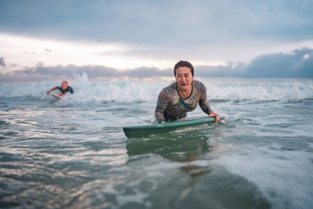istock Determined Asian Female Surfer Riding Waves at Gold Coast 2194826703