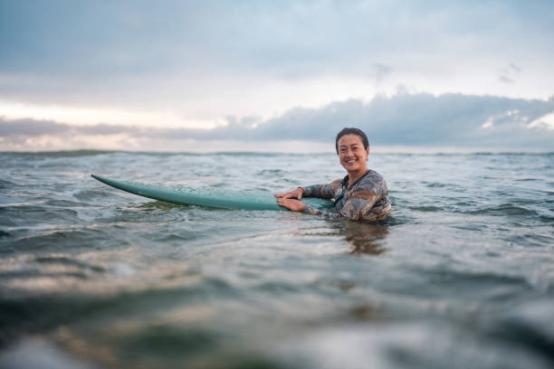 istock Joyful Asian Female Surfer Riding Waves at Gold Coast 2194826704