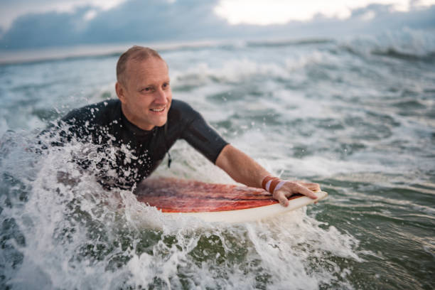istock Determined Male Surfer Riding Waves at Gold Coast Beach 2194826715