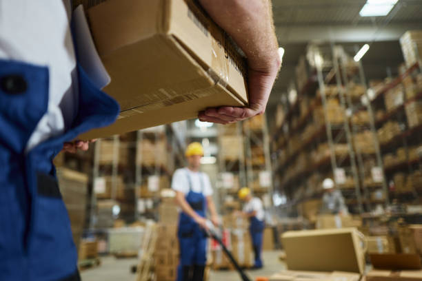 istock Close up of a warehouse worker with a package in storage room. 2194827059
