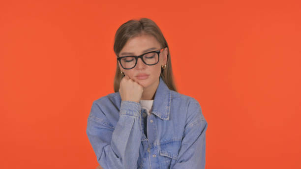 istock Sleeping Casual Young Woman on Orange Background, Portrait 2194828351