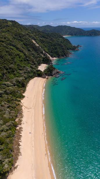 istock Pristine beach with turquoise waters and lush hills 2194828566