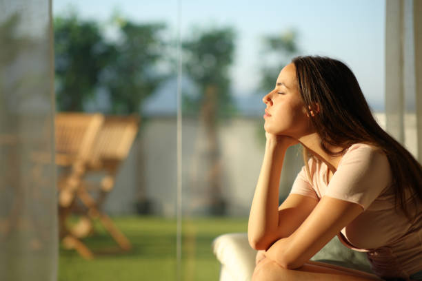 istock Woman relaxing closing eyes at sunset at home 2194829497