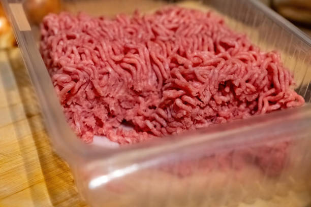 istock Freshly ground beef in a transparent container on a wooden surface ready for cooking 2194830356