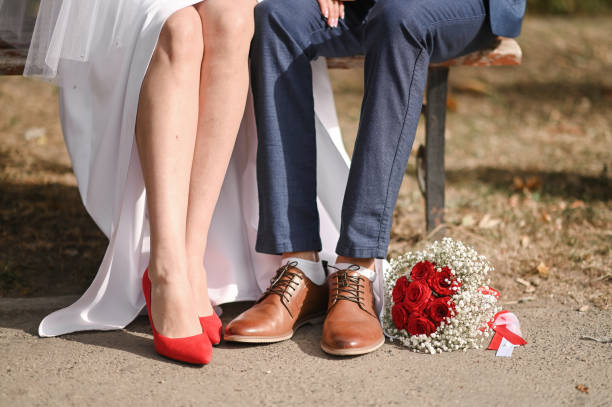 istock the bride and groom on a bench in the park 2194831046