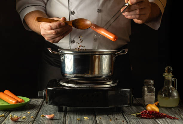 istock In a cozy kitchen, a chef adds fresh sausages and black pepper to a simmering pot, creating a delicious meal. The warm lighting enhances the culinary atmosphere filled with rich aromas 2194831755