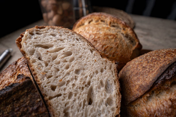 istock Golden-Crusted Artisan Sourdough Bread on a Rustic Wooden Table. 2194832021