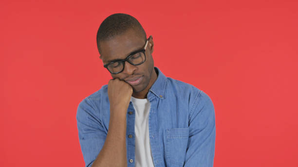 istock Sleeping Casual African Man on Red Background, Portrait 2194832602