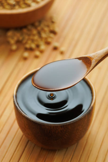 istock soy sauce pouring in bowl with splash and drop and dry soybeans on table 2194833270