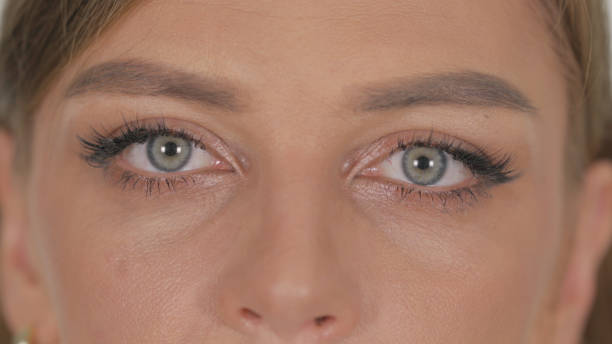 istock Close up of Female Blinking Eyes on White Background 2194836069