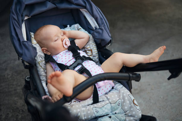 Beautiful baby girl sleeping in stroller.