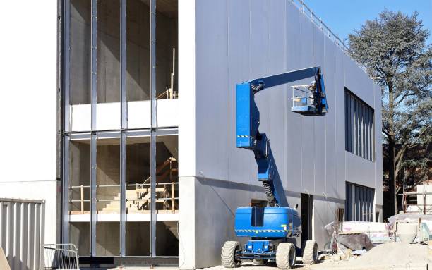 istock Cherry picker next to a prefab industrial building under construction. 2194841248