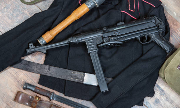 istock german machine gun is on a table next to a knife. Scene is tense and ominous 2194841644