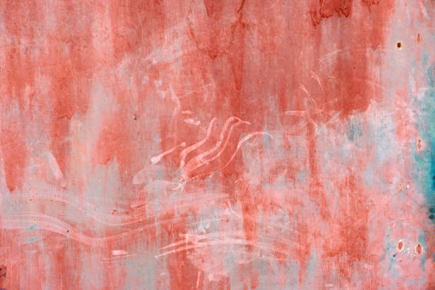 A close-up of a red and blue textured surface with white marks and scratches