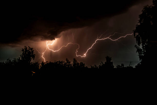 istock beautiful lightning during a thunderstorm at night in a forest that caused a fire, against a dark sky with rain 2194843542