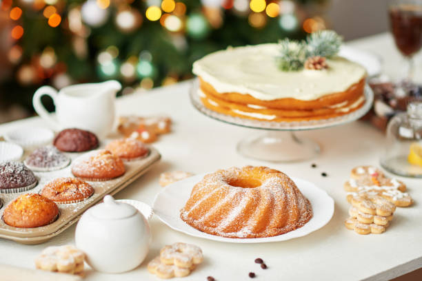 istock Christmas cake and sweets on table. Christmas decorations with lights background. Happy New Year! Christmas greeting card. Winter card template. Xmas concept. Holiday Banner. Feast of Nativity. 2194843556