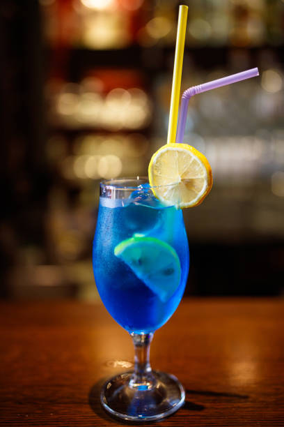 istock Refreshing Blue Cocktail with Lemon Garnish on Wooden Bar Counter 2194844915