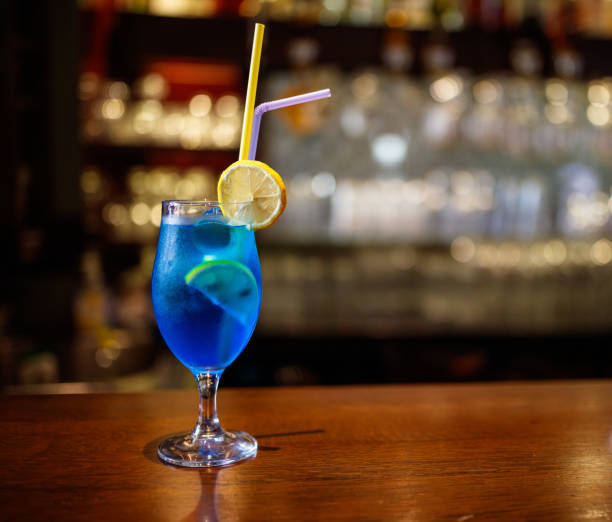 istock Refreshing Blue Cocktail with Lemon Garnish on Wooden Bar Counter 2194844930