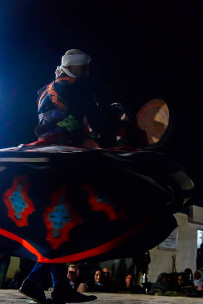 Hurghada, Egypt - December 10, 2018: Man performs egyptian traditional tanoura dance in the desert camp in Egypt