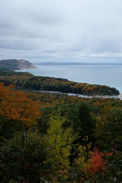 istock Autumn forest by a serene lake under cloudy sky. 2194845830