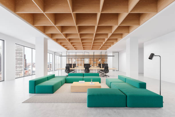istock Modern coworking office interior with green sofa seating and workstations, featuring open space, wooden ceiling, and large windows. 3D Rendering 2194847401