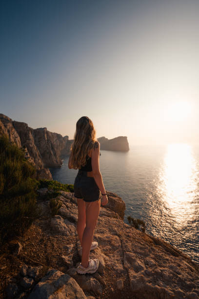 istock A traveler admires Mallorca's rocky cliffs glowing in the evening sunlight. 2194847757